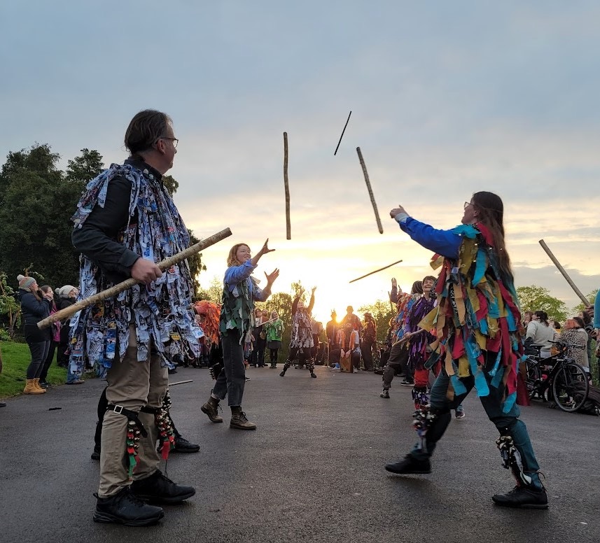 Dancers throwing sticks.