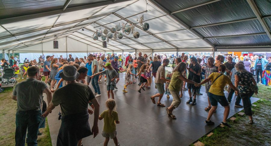 Lots of people dancing in a marquee.