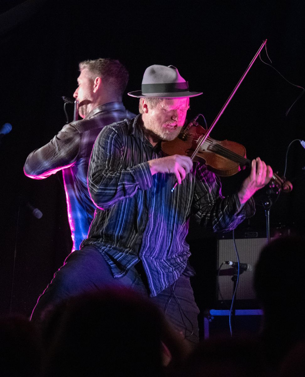 Two men playing musical instruments.